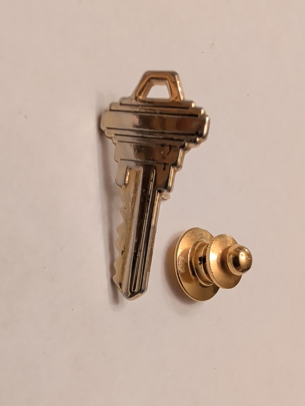 Gold Key-Shaped Lapel Pin
